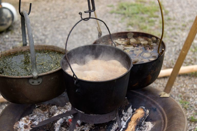 Pots boiling over a fire